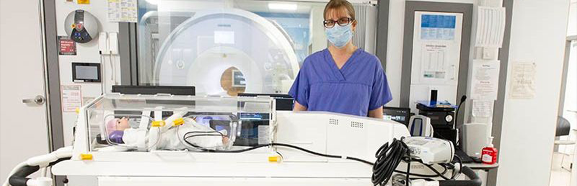 Dr in scrubs and a mask with the mri incubator