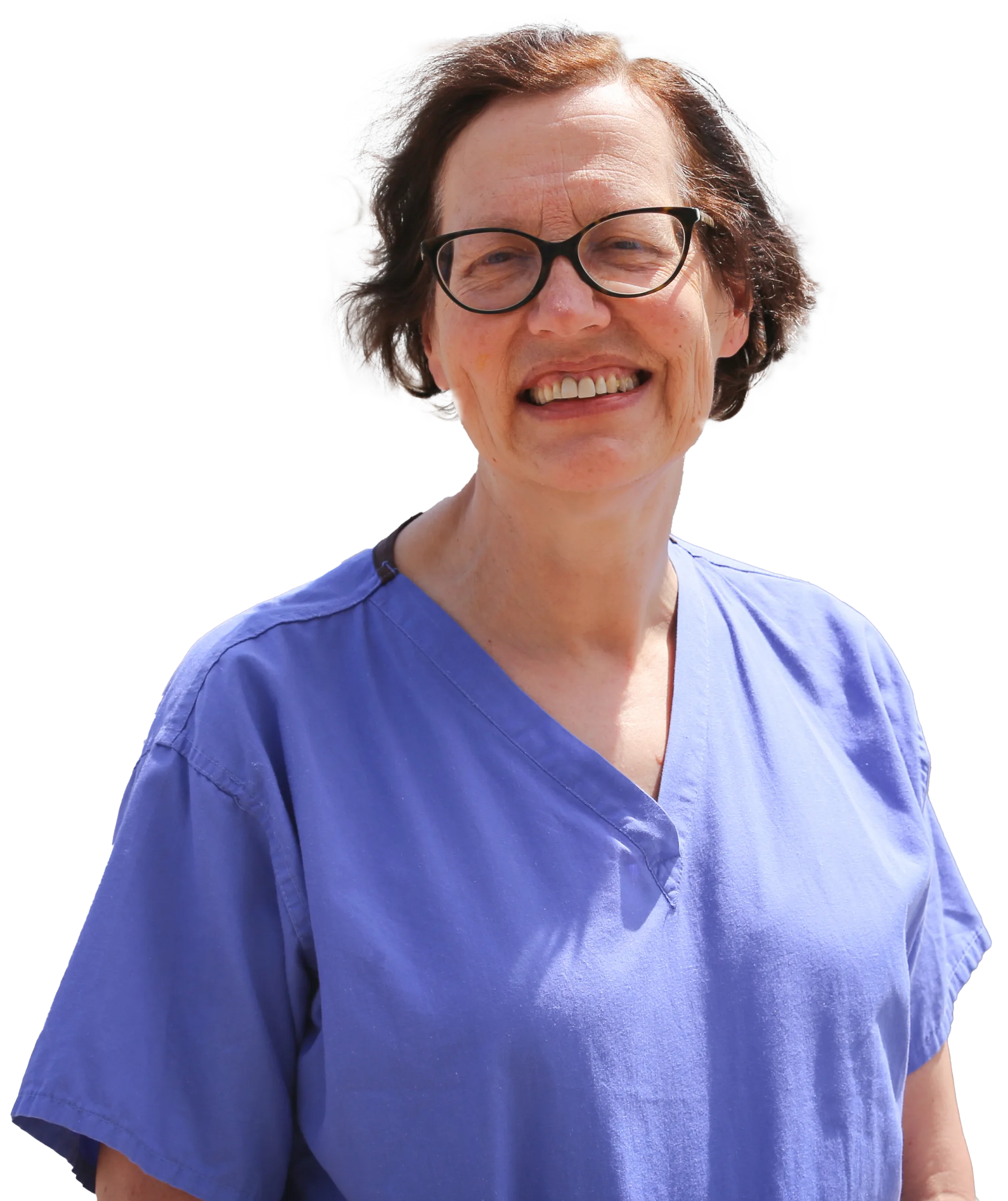 Surgeon Ms Carin Van Doorn, smiling. Carin has short, dark hair and is wearing glasses and blue scrubs