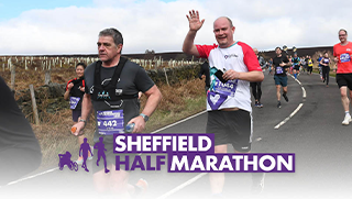 Man running on road, waving at camera wearing CHSF running tshirt