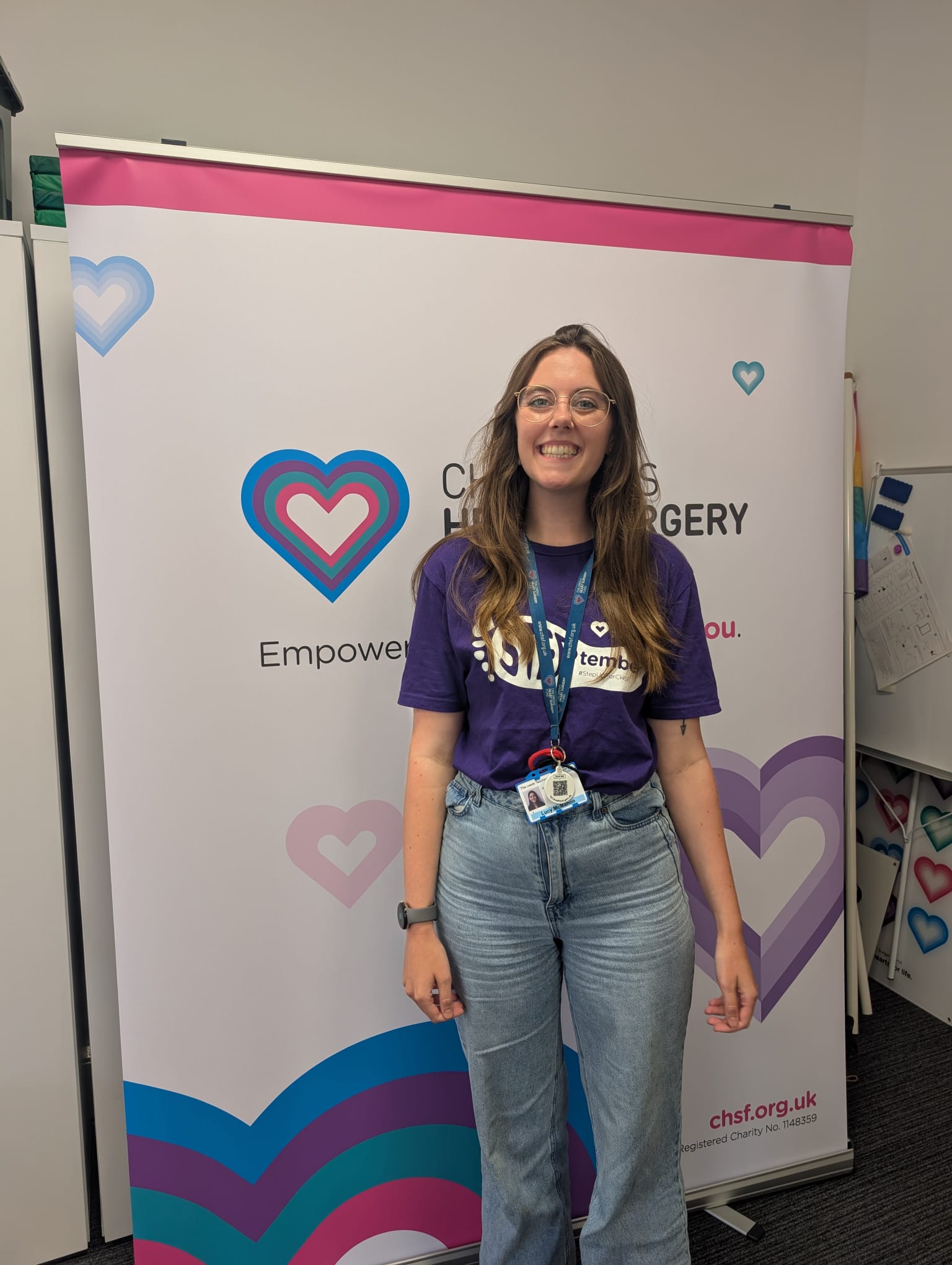 Family & Youth Support Worker Lu wearing her purple Steptember t-shirt in the CHSF office, smiling