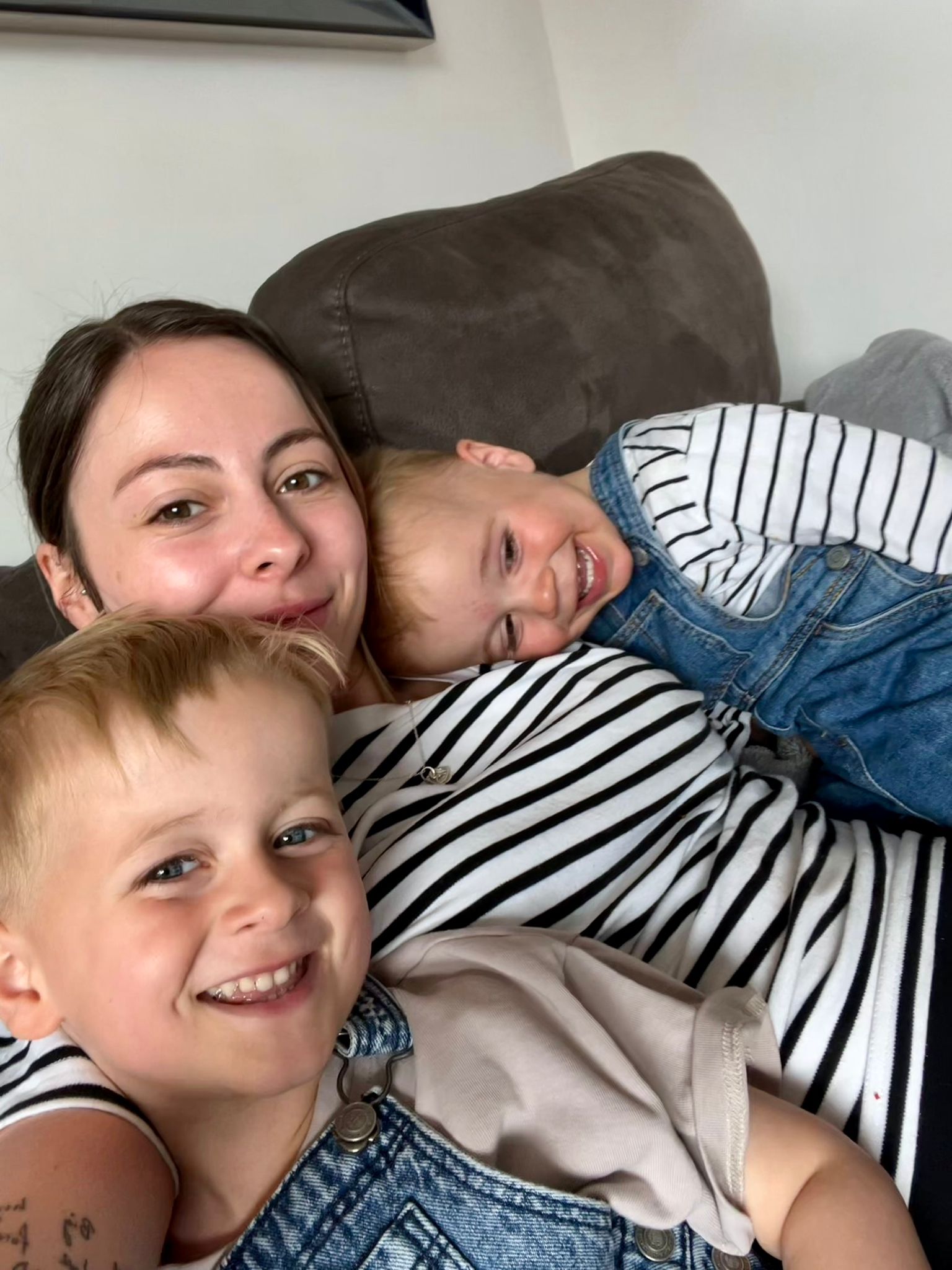 The Jackson Family at sunrise on top of Snowdon, holding a green CHSF banner