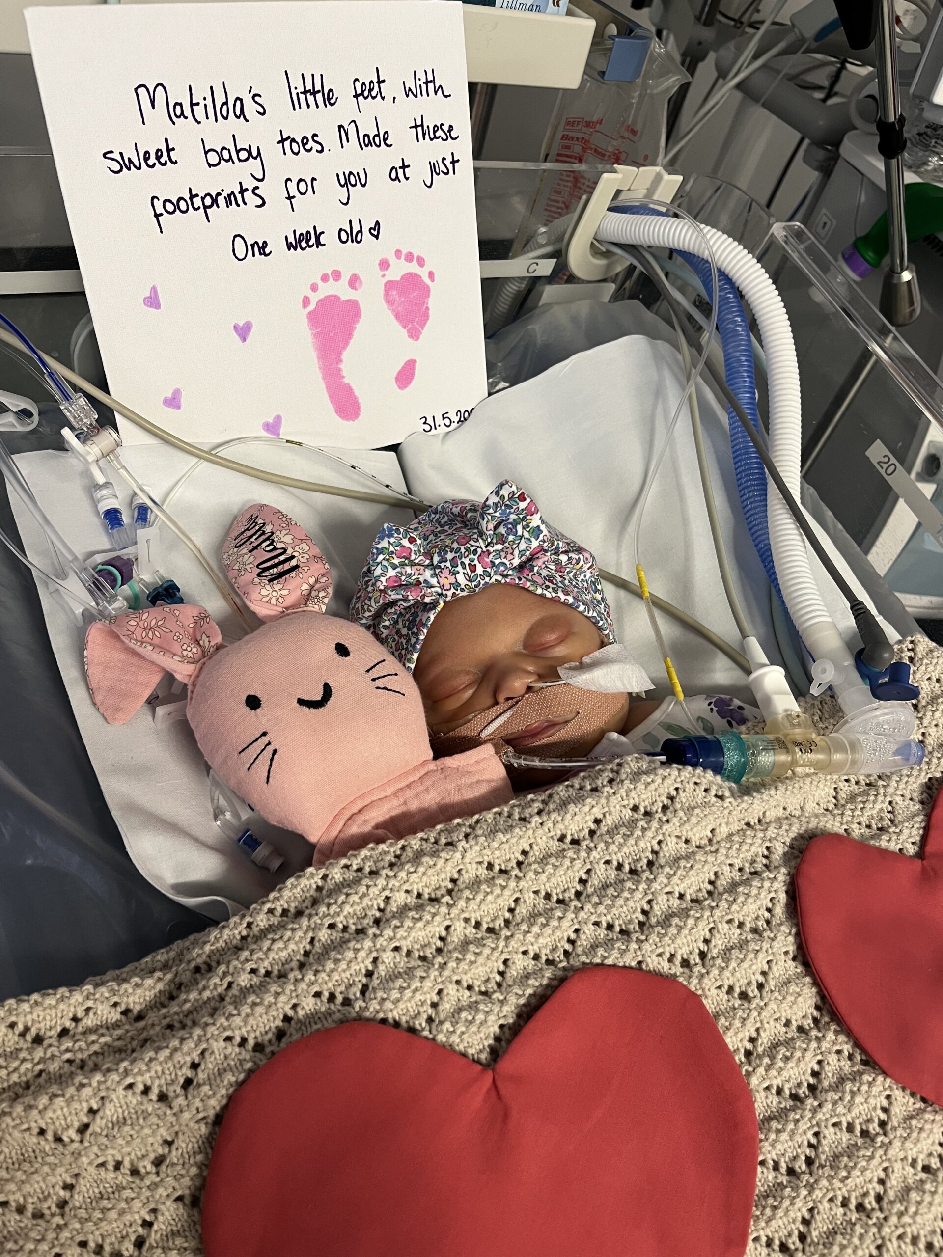 Matilda in hospital, asleep next to a pink rabbit