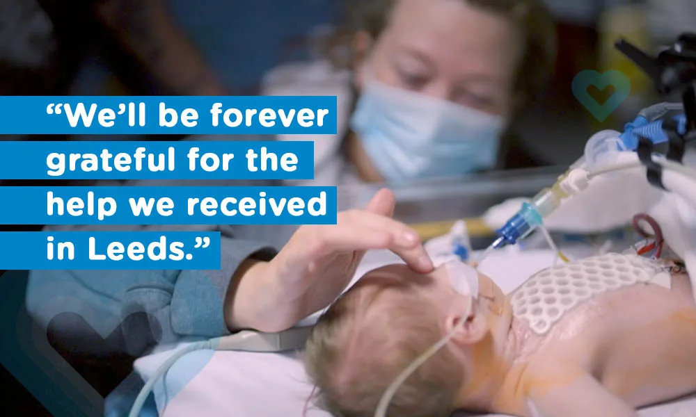 Mum wearing mask in hospital at the bed side of her baby who has just had open heart surgery