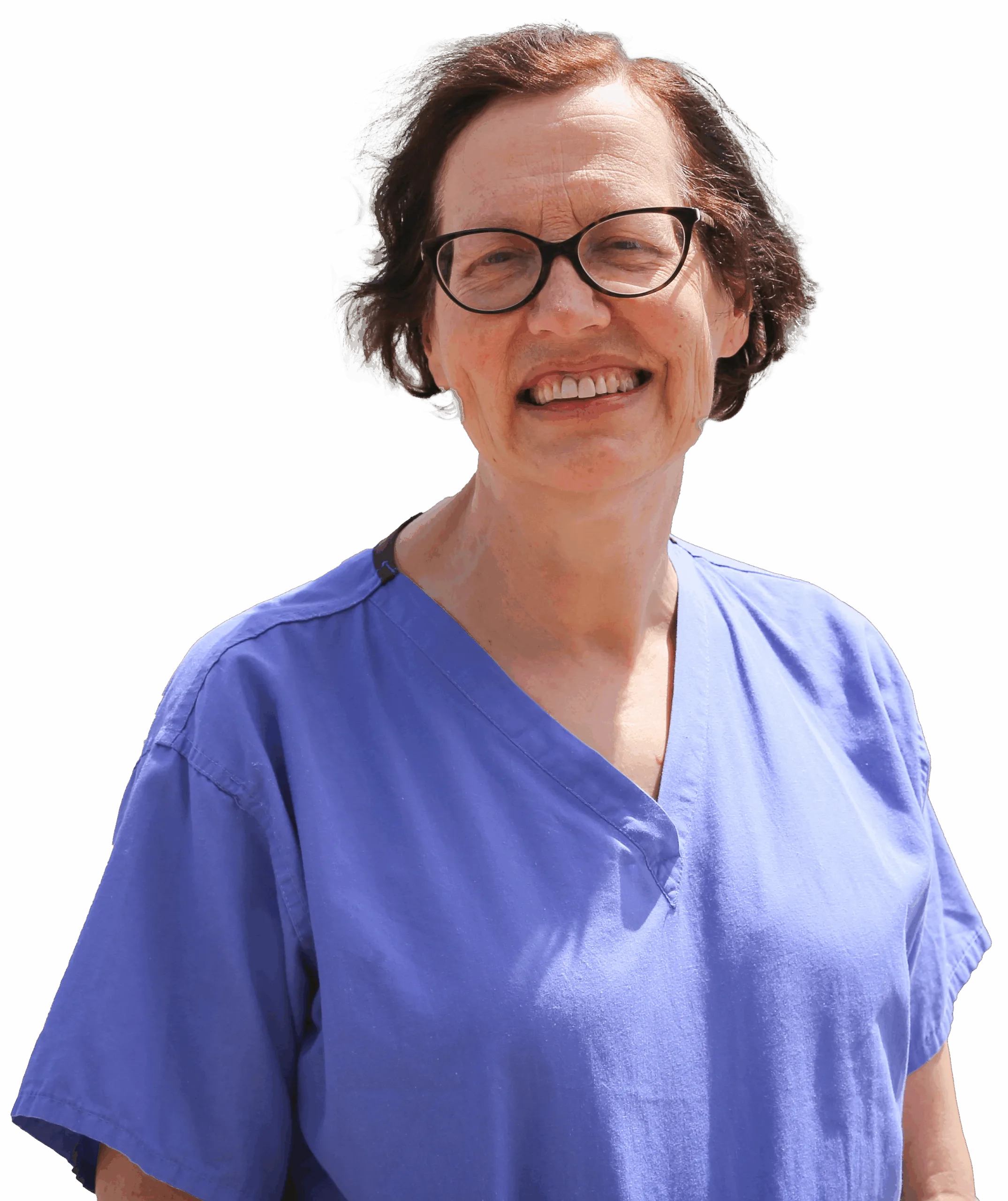 Surgeon Ms Carin Van Doorn, smiling. Carin has short, dark hair and is wearing glasses and blue scrubs