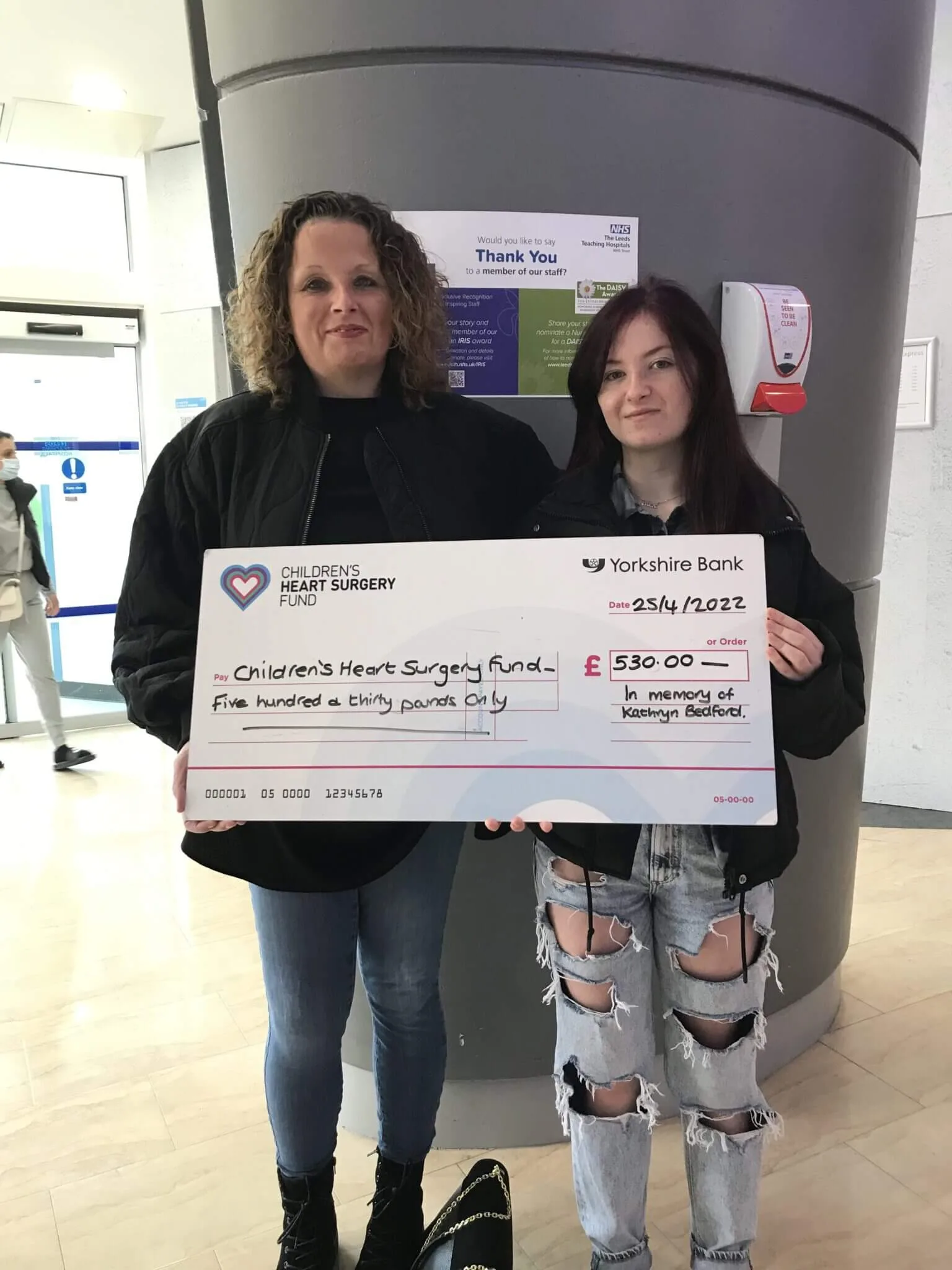 Deborah and Millie holding a big cheque for £530 for CHSF
